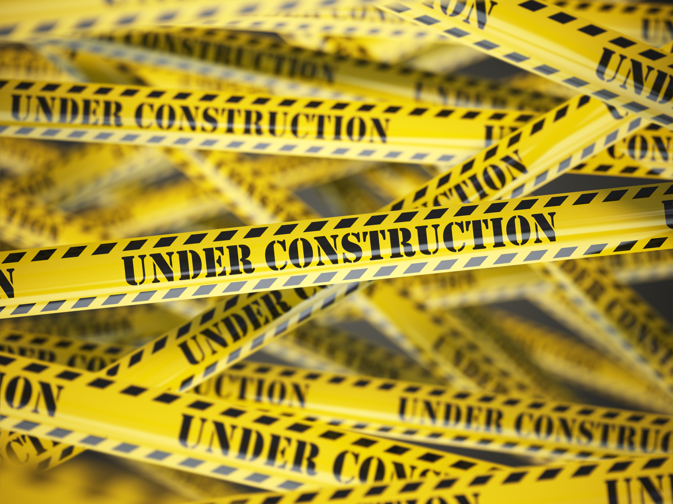 Under construction yellow caution  tape background.